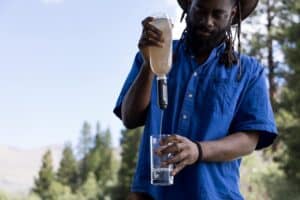 Refreshing homemade electrolyte drink outdoors for survival hydration.