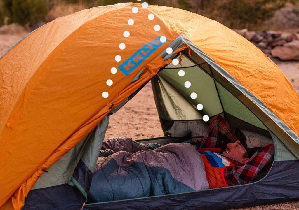 Two-vestibule camping tent with orange rainfly and interior space for sleeping outdoors.