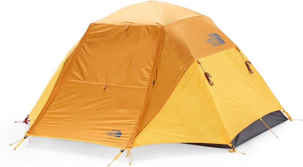 Lightweight orange outdoor camping tent with durable rainfly and secure stakes.