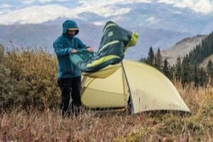 High-quality camping tent set up outdoors in scenic mountain landscape.