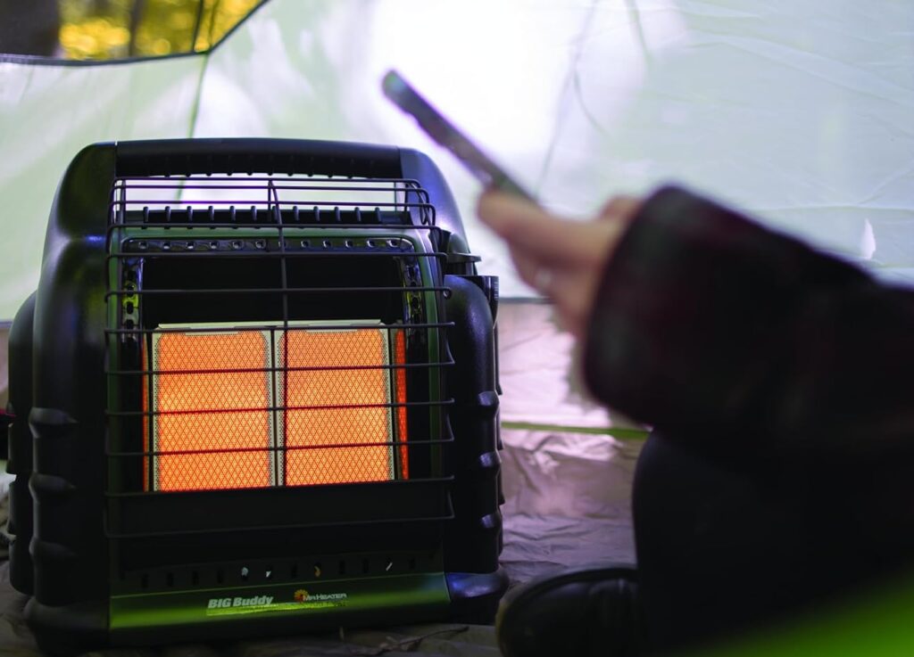 Portable camping heater inside tent, outdoor survival gear for camping and emergency preparedness.