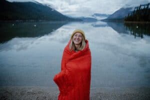 Warm outdoor sleeping bag for camping and survival gear in scenic natural setting.