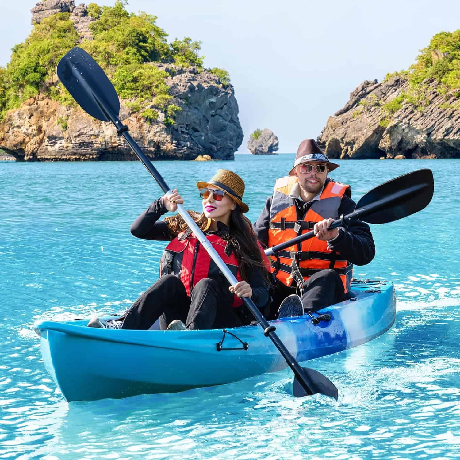 Kayakers paddling in turquoise water near rocky islands, outdoor adventure, survival gear, ocean exploration.