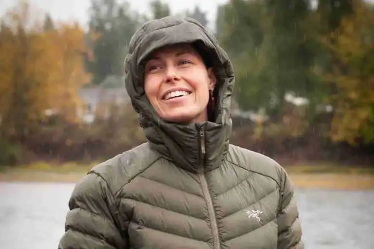 Warm insulated outdoor jacket with hood, suitable for camping, hiking, and survival gear activities.