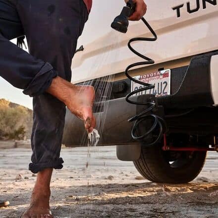 High-quality outdoor survival gear beside a vehicle, showcasing preparedness for emergencies and off-grid adventures. Ideal for camping, wilderness survival, and outdoor enthusiasts.